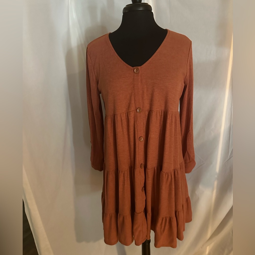 Ladies dress. It is rust in color. It is a size medium. Like new